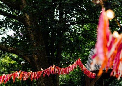 pink and orange bunting hung in the woods.